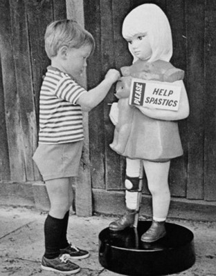 A child putting money in a plastic model of a disabled child, who has callipers on her legs and a sad expression, holding a sign saying 'help spastics'